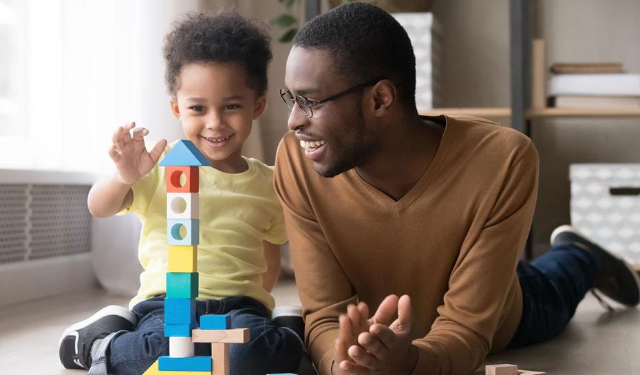 Parent and child building toy tower together